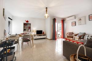 a living room with a couch and a table at Casa Farol in Portimão