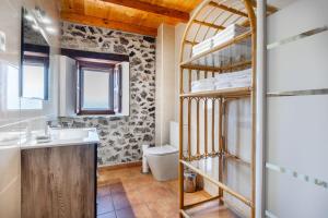 a bathroom with a sink and a toilet at Casa Trasmiera in Solórzano +19 photos