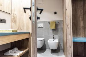 a bathroom with a toilet and a sink at Mysciliar Apartment Tree I in Siusi