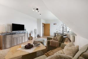 a living room with a couch and a tv at Ferienwohnung Storchennest in Burg