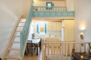 a kitchen and a dining room with a loft at Karai traditional house in Astypalaia