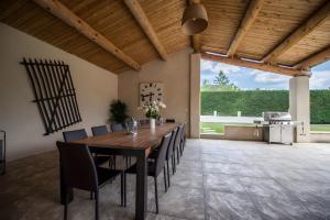 a dining room with a wooden table and chairs at Le Mas Du Batadou in Visan