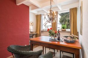 a dining room with a wooden table and chairs at Dachatelier Überlingen in Überlingen