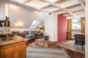 a living room with a couch and a table at Dachatelier Überlingen in Überlingen