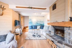 a living room with a fireplace and a couch at Chalet Marmotte in Saint-Martin-de-Belleville