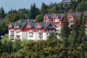 a large apartment building on a hill with trees at Ferienwohnung Tannenblick 3-2-3-3 in Oberhof