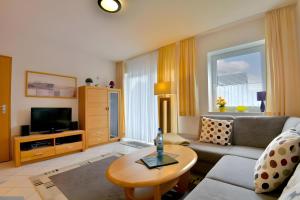 a living room with a couch and a table at Ferienwohnung Tannenblick 3-2-3-3 in Oberhof