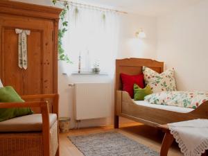 a bedroom with a bed and a radiator and a window at Gästehaus Minkel in Gudensberg