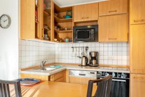 a kitchen with a sink and a microwave at Ferienwohnung Tannenblick 3-2-3-3 in Oberhof +10 photos