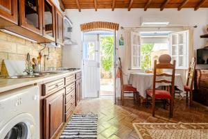 a kitchen with a table and a dining room at Casa Da Guia in Beja +14 photos