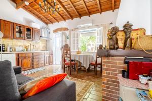 a kitchen and living room with a couch and a table at Casa Da Guia in Beja