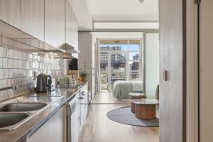 a kitchen with a sink and a table at Backup-Powered Trendy City Balcony Apartment in Cape Town