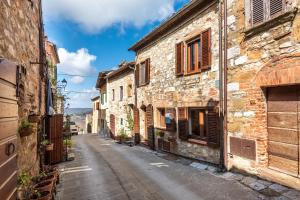 an alley in an old town with stone buildings at Oasi del borgo Montefollonico in Montefollonico