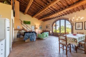 a kitchen with a table and chairs in a room at Agriturismo Paugnano in Radicondoli