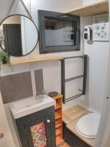 a small bathroom with a sink and a toilet at La Charmotte in Verbiesles
