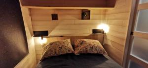 a bedroom with a headboard with two pillows on a bed at La Charmotte in Verbiesles
