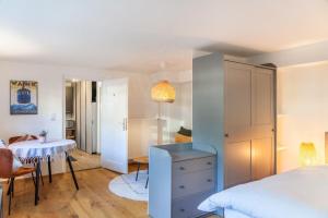 a bedroom with a bed and a dining room with a table at Höllental 51 in Garmisch-Partenkirchen