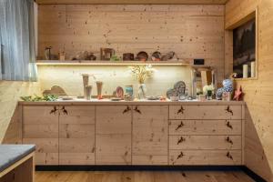 a kitchen with wooden walls and a counter top at Hatzes App Langkofel in Laion