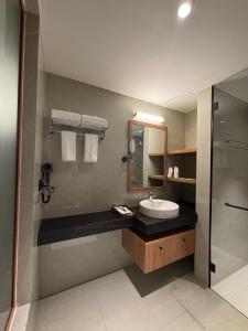 a bathroom with a sink and a mirror at Olive Woods in Chinnakanal +31 photos