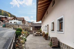 a house with a sidewalk next to a street at Hatzes App Langkofel in Laion