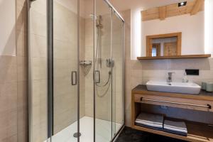 a bathroom with a shower and a sink at Hatzes App Langkofel in Laion +19 photos