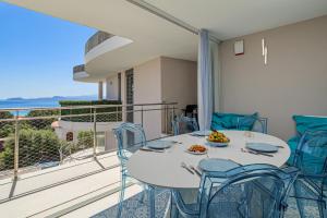 a dining room with a table and chairs on a balcony at Pascoli Suite - by And Service in Golfo Aranci