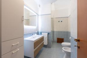 a white bathroom with a sink and a toilet at Summer Spritz in Custonaci +32 photos