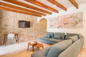a living room with a couch and a tv at Finca Rafal in Son Servera