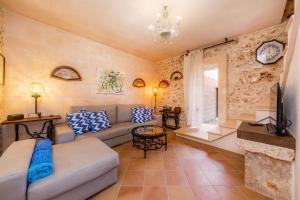 a living room with a couch and a fireplace at Finca Fonoll in Santa Margalida