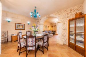 a dining room with a table and chairs at Finca Fonoll in Santa Margalida