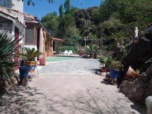 a patio with potted plants next to a house at Vega Fuente de las Moreras in Burunchel +20 photos