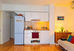 a kitchen with a white refrigerator in a room at Dream Home in Lopud