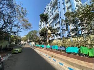 a car parked on a street next to a building at Large room with terrace in Kolkata