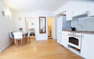 a kitchen with white cabinets and a table with chairs at Dream Home in Lopud +8 photos