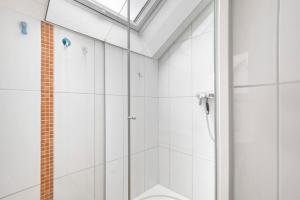 a shower with a glass door in a bathroom at Haus Bross in Hayingen +24 photos