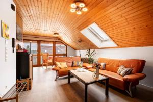 a living room with a couch and a table at Haus Bross in Hayingen