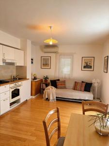 a living room with a couch and a table at Dream Home in Lopud
