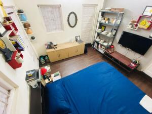 a room with a blue sheet on the floor at Large room with terrace in Kolkata
