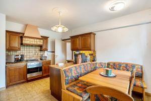 a kitchen with a couch and a wooden table at Apartment Albert-Schulte Park in Worms