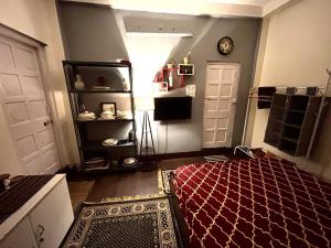 a room with a bed and a door with a clock at Large room with terrace in Kolkata