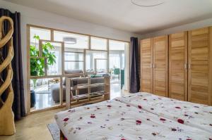 a bedroom with a bed with flowers on it at Ferienparadies Bodensee Fewo2 in Billafingen +24 photos