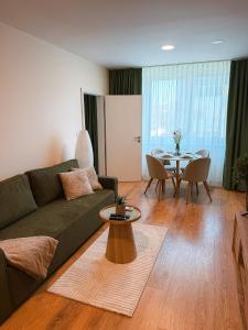 a living room with a couch and a table at Bloom Olive Apartment in Trenčín +44 photos