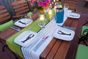 a wooden table with plates and wine glasses and flowers at Haus Seezeit in Malchow +15 photos