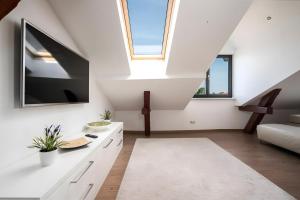 a living room with white walls and a skylight at Haus Seezeit in Malchow