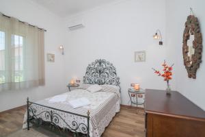 a bedroom with a bed and a dresser in it at Maison Chloe in La Maddalena
