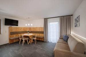 a living room with a couch and a table at Vernalhof Apt Sunnaseit in Sluderno