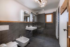 a bathroom with a sink and a toilet and a shower at Vernalhof Apt Sunnaseit in Sluderno +10 photos