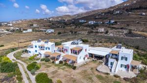 an aerial view of a house with a hill in the background at Anemologio 102 Tinos in Agios Ioannis