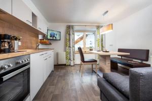 a kitchen with a table and a dining room at Haus Sabrina Masnerjoch in See