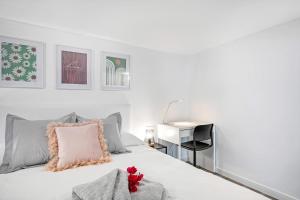 a bedroom with a white bed with a red flower on it at Loft El Ramonal in Candelaria